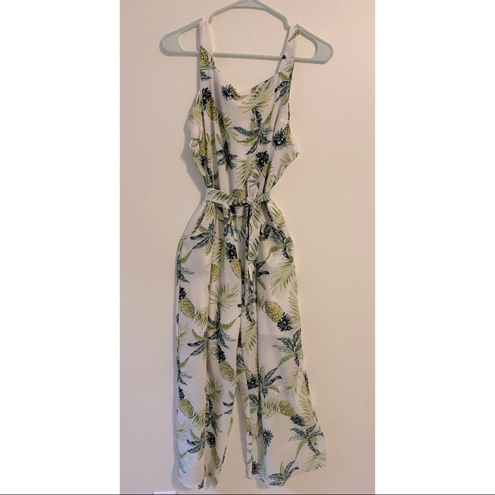 White jump suit with pineapple and palm leaves